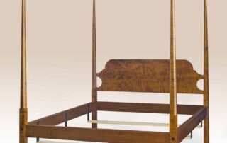 Syracuse Pencil Post Bed with pencil posts and shaped headboard, available in cherry wood, tiger maple, or primitive painted finish, American made.