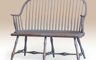 Historical Nantucket Windsor Bench in Williamsburg blue over red finish with bamboo-style turnings, ideal for hallways or foyers.