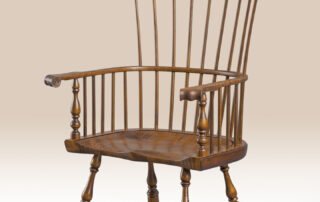 Historical Tiger Maple Philadelphia Windsor Armchair with carved ears, knuckles, and a shaped seat in tiger maple wood.