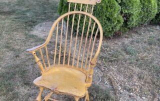 Painted Historical Continuous Arm Windsor Chair with comb in mustard over red finish, perfect for adding color and rustic charm, American made.