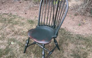 Painted Historical Bow Back Side Windsor Chair with Brace in Historical Black Green over Red Finish, ideal for dining or kitchen tables.