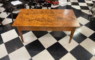 Upton Coffee Table in tiger maple wood with clean lines, suitable for diverse settings, American made.