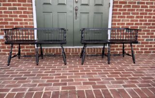 Pair of Hardwick Low Back Windsor Settees with shaped seat in antique black over red crackle finish, American-made.