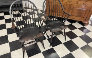 Pair of Historical New York Continuous Windsor Armchairs with brace in antique black over red crackle finish, perfect for dining or accent use, American made.