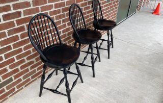 Set of three Historical Swivel Low Bow Back Windsor Stools with 25in seat height in antique black over red crackle finish, American made.