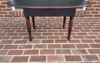 Rustic Coffee Table with oval top and black over red primitive finish, ideal for country-style decor, American made.