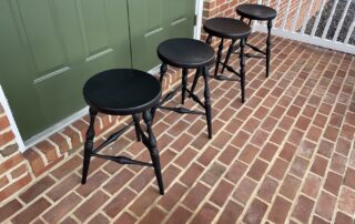 Set of four Historical Pennsylvania Stools in Antique Black over Red Crackle Finish, 25-inch seat height, ideal for 36-inch counter height