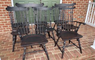 Set of 8 Fan Back Windsor Chairs with 2 armchairs and 6 side chairs in antique black over red finish, classic Windsor design, American made.