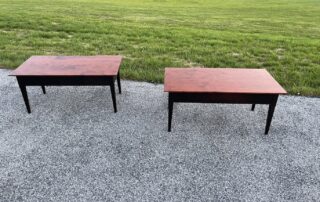 Pair of coffee tables with cherry wood tops and antique black over red painted base, ideal for family or living rooms, Pennsylvania made.