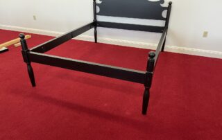 Queen Size Historical Charlton Bed with Antique Black over Red Crackle frame, cannonball motif, and decorative headboard, American made.