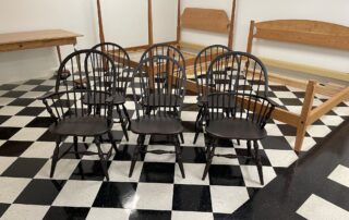 Set of 6 Jefferson Windsor Chairs with 2 armchairs and 4 side chairs in antique black over red finish, American made.