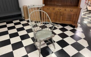 Historical Sack Back Windsor Armchair with Comb in Plymouth Blue over Red, bamboo style turnings, suited for antique or period settings.