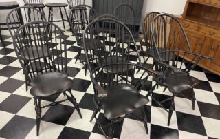 Set of 8 Windsor chairs with 2 Sack Back armchairs and 6 Bow Back side chairs in antique black over red crackle finish, American made.