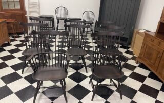 Set of 8 New England Fan Back Windsor Chairs with 2 armchairs and 6 side chairs in antique black over red finish, American made.