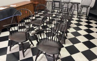 Set of 6 Windsor Chairs with 2 Sack Back Armchairs and 4 Bow Back Side Chairs in Antique Black over Red Finish.