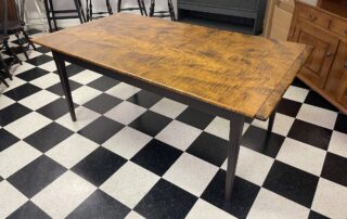 6 ft Pennsylvania Farm Table with Light Hand Planed Tiger Maple Top, Breadboard Ends, and Antique Black over Red Tapered Leg Base.