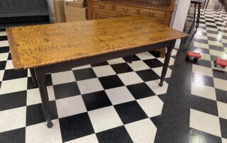 6ft Pennsylvania Turned Leg Farm Table with Tiger Maple Top and Antique Black over Red Base, featuring breadboard ends and turned legs.