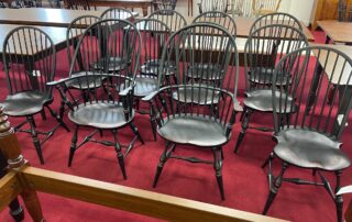 Set of 12 Historical Windsor Chairs, including Sack Back Armchairs and Bow Back Side Chairs in Antique Black over Red Crackle Painted Finish.