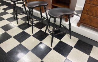 Set of 3 Historical Saddle Seat Kitchen Stools with 25in seat height in Antique Black over Red Crackle Painted Finish.