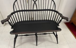 Double Sack Back Windsor Settee with Antique Black over Red Crackle Finish, American made.