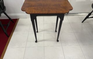 Cookie Cutter End Tea Table with tiger maple wood top and antique black over red base, American made.