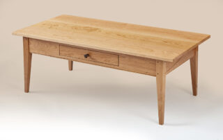 Enfield Shaker Coffee Table in natural cherry wood with walnut drawer pull and dovetailed drawer.