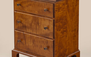 New Lebanon Three Drawer Shaker Stand with dovetailed drawers, walnut pulls, and Shaker design, offered in cherry, tiger maple, or painted finishes. American made.