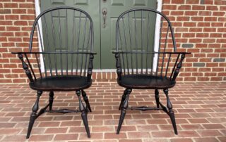 Pair of Historical Sack Back Windsor Armchairs with antique black over red crackle finish, ideal for dining or accent use, American made.