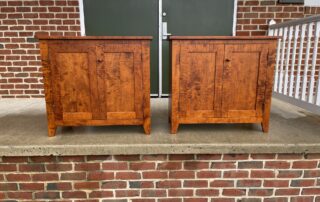 Shaker-style tiger maple wood bookcases with paneled doors and walnut drawer pulls, perfect for family or living room decor