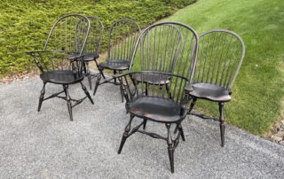 Set of 6 Farmhouse Chairs with 2 Sack Back Windsor armchairs and 4 Bow Back Windsor side chairs in antique black over red crackle finish, American made.