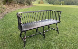 Painted Windsor Bench in antique black over red crackle finish with classic Windsor style and turned legs, handcrafted in the USA.