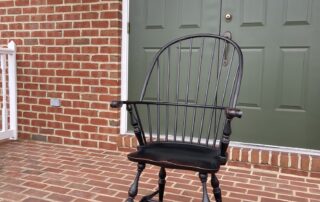 Historical Sack Back Windsor Armchair with Carved Knuckles in Antique Black over Red Crackle Finish, American Made