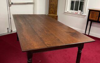 7ft Lancaster County Farm Table featuring hand-planed cherry wood top and antique black over red turned legs, crafted in Pennsylvania.