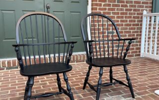 Pair of Jefferson Windsor Armchairs in antique black over red finish with turned legs and classic Windsor style, made in Pennsylvania.