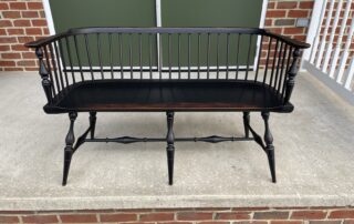 An American-made Historical Low Back Windsor Settee, embodying the essence of farmhouse decor with its classic Windsor style.