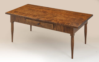 Shaker Coffee Table with Drawer featuring turned legs, dovetailed storage, and customizable finishes, including Tiger Maple and Cherry Wood.