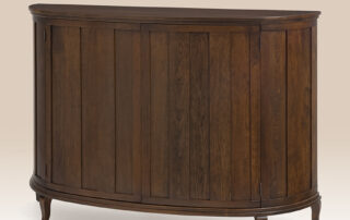Designer Demi Lune Cabinet in cherry finish with two adjustable shelves.