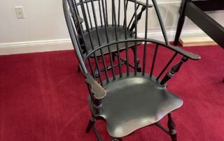 Pair of Historical Sack Back Windsor Armchairs with Shield Seats and Antique Black over Red Crackle finish, perfect for dining spaces.