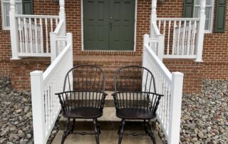 A pair of Sack Back Windsor Armchairs, crafted with vase turned legs and featuring intricate Pennsylvania craftsmanship.