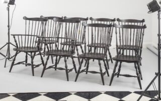 Set of 8 Fan Back Windsor Chairs with turned legs, antique black over red finish, and classic Windsor design, ideal for period-style dining.