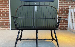 A beautifully crafted Pennsylvania-made Sack Back Windsor Settee with Comb, featuring a decorative comb and simple carved ears.
