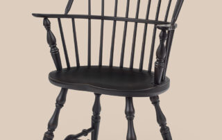 Sack-Back Windsor Armchair with classic Windsor design, sack back, turned legs, and solid construction. Ideal for dining or accent use.