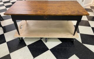A Shaker style coffee table with a dovetailed drawer, crafted in the USA. Featuring simple turned legs and classic Shaker design.