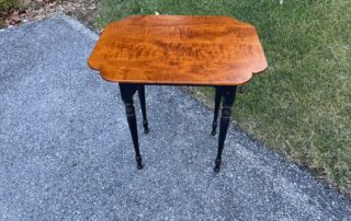A beautifully crafted Sheraton style side table, made in the USA, featuring a Tiger Maple Wood Cookie Cutter End Top with a unique shape that highlights the wood's natural grain.