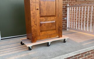 Tiger Maple Simple Raised Panel Cupboard with raised panel door, scalloped apron, and walnut door pull, part of the Historical series.