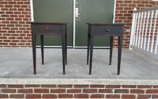 Pair of Primitive One Drawer Stands with rustic black over red finish, tapered legs, and dovetailed drawer. Ideal for farmhouse decor.