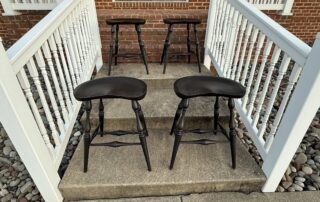 Saddle seat stool with mortised and wedged construction for farmhouse kitchens.