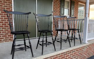 Set of four Fan Back Windsor Stools with carved ears and shaped seat.