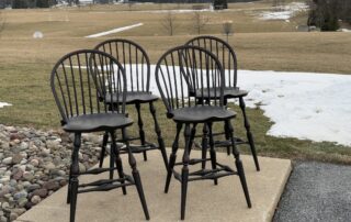 Set of 4 Low Bow Back Windsor Stools with antique black over red crackle finish. Classic non-swivel counter seating.