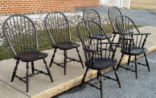 Set of 6 Pennsylvania Made Windsor Chairs with Sack Back Armchairs and Bow Back Side Chairs in antique black over red finish.